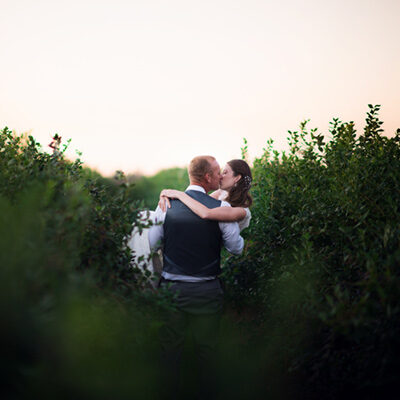 portland wedding photography bride groom kiss field